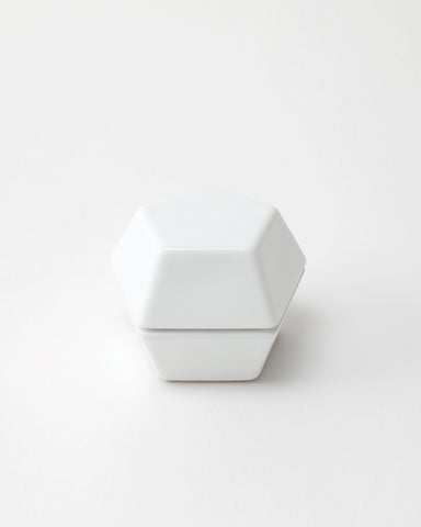 White geometric spice mill on a light gray background