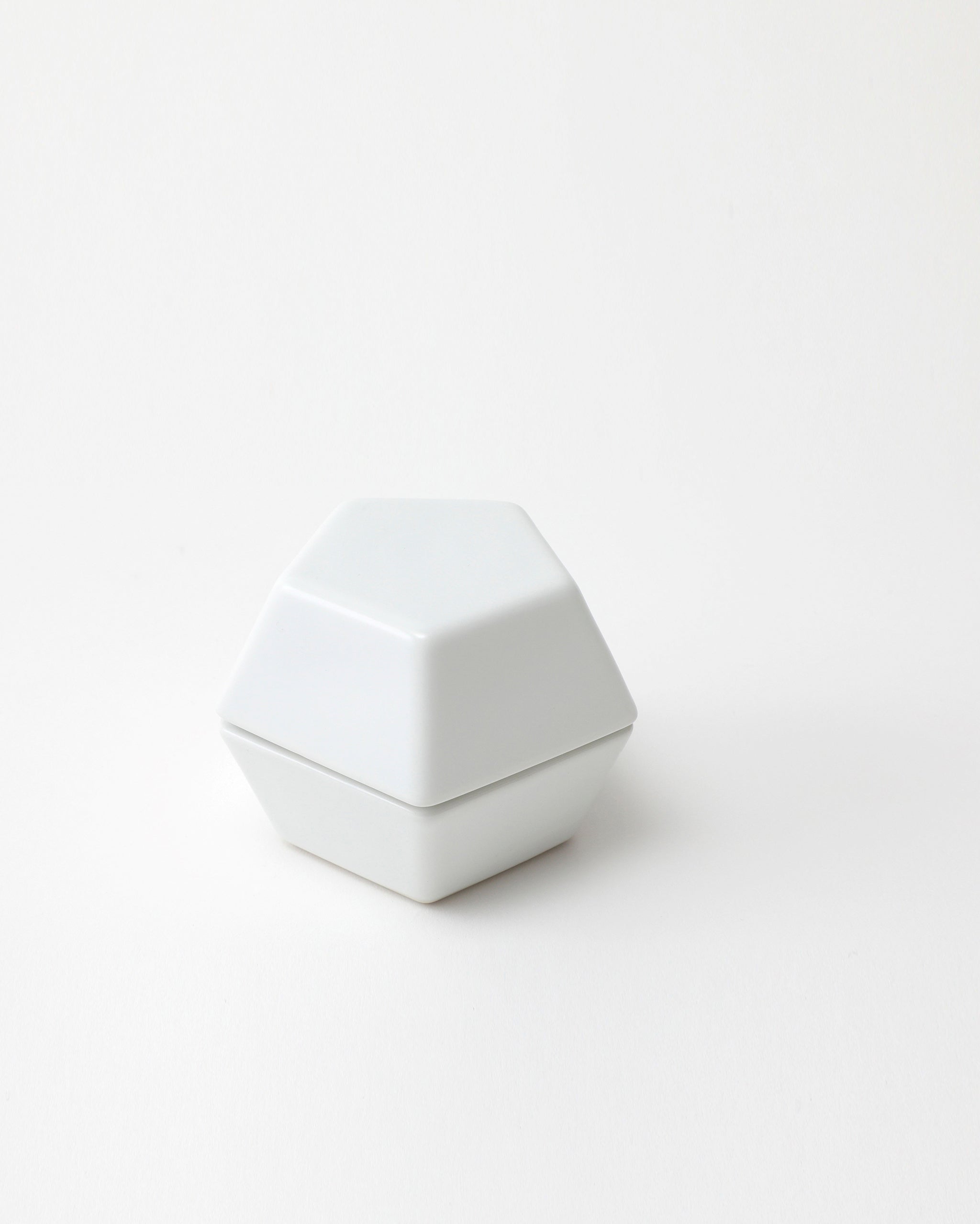 White geometric spice mill on a light gray background