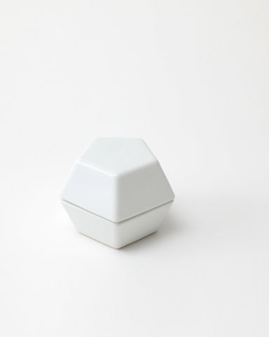 White geometric spice mill on a light gray background