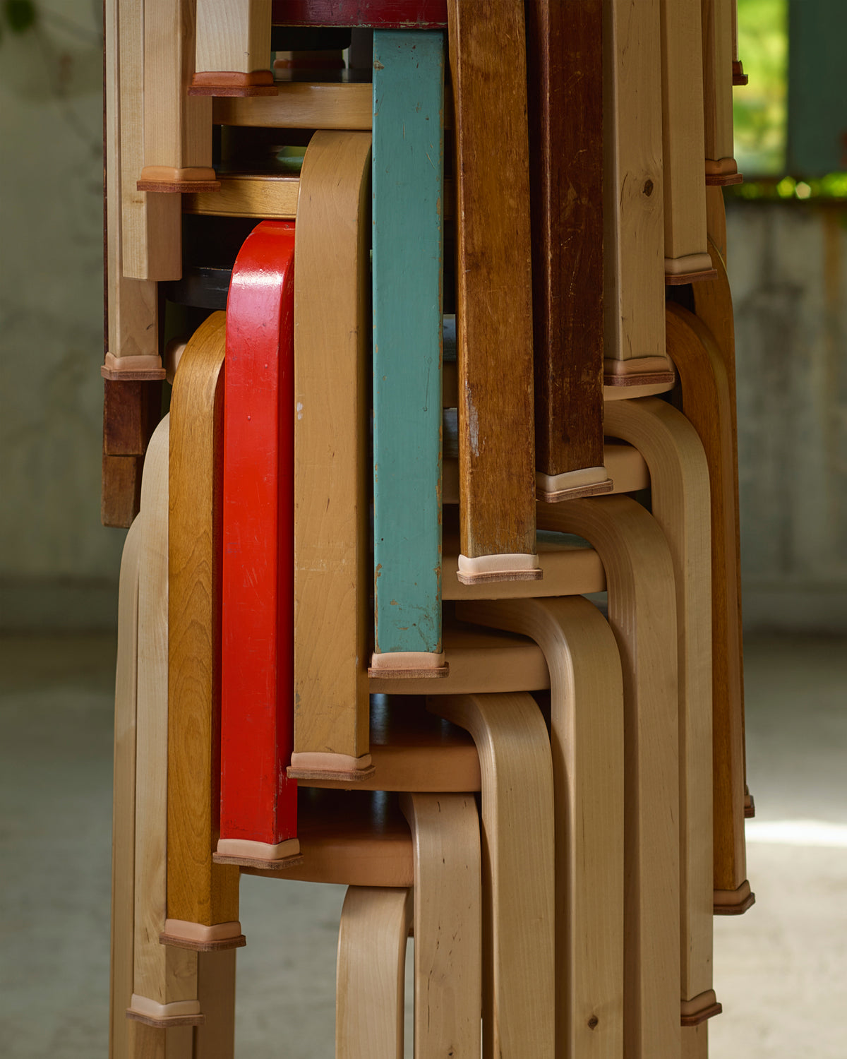 Stools stacked wearing shoes by Artek and Hender Scheme 