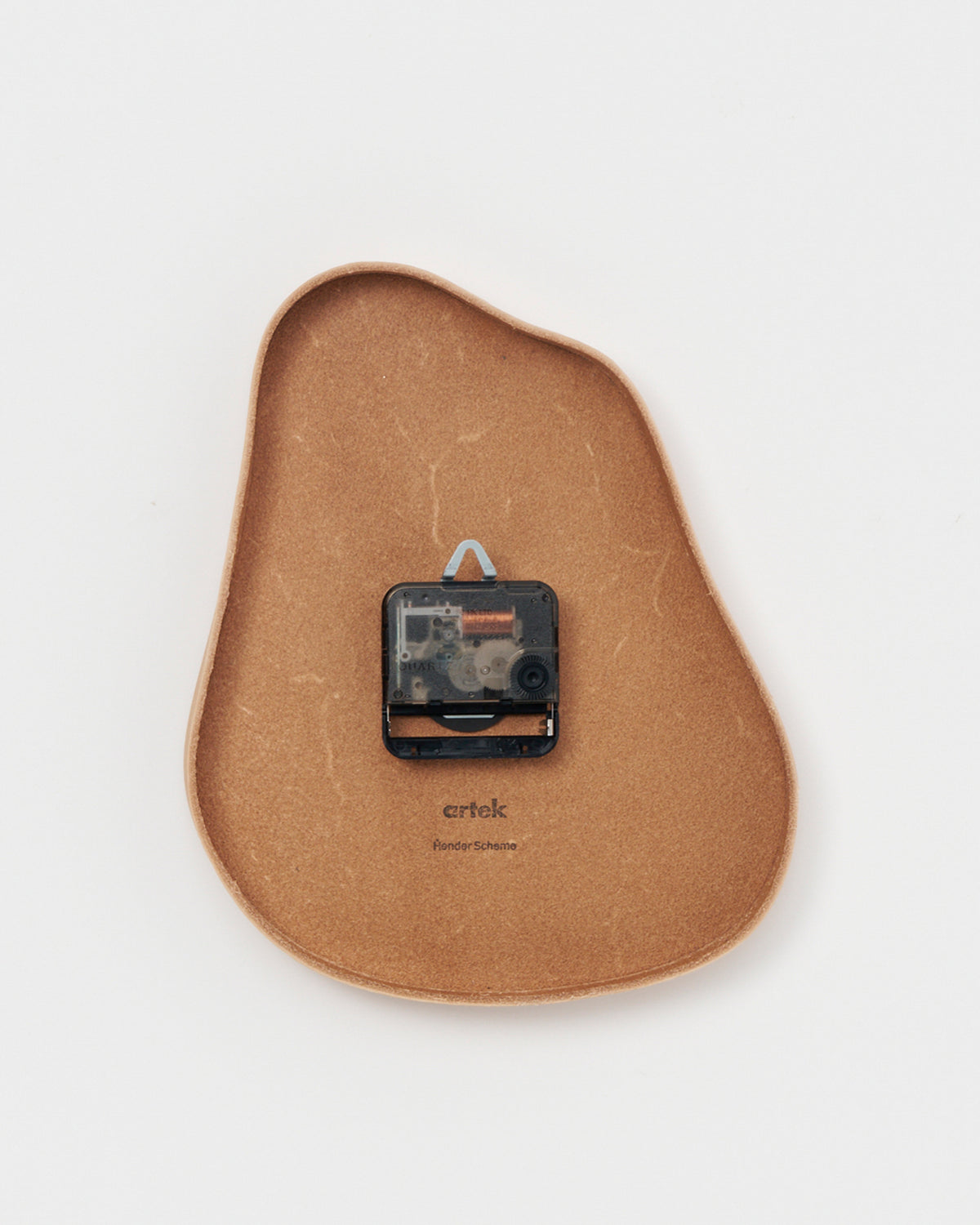 Back side of leather Clock by Hender Scheme on a gray background