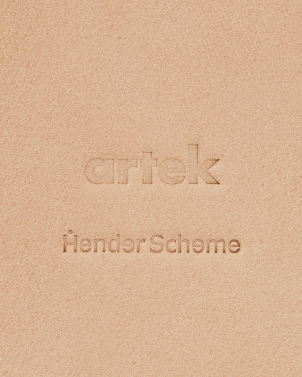Up-close of Coaster by Hender Scheme and Artek on a gray background