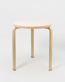 Table with Shoes by Artek and Hender Scheme on gray background