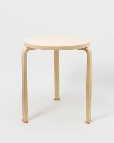 Table with Shoes by Artek and Hender Scheme on gray background