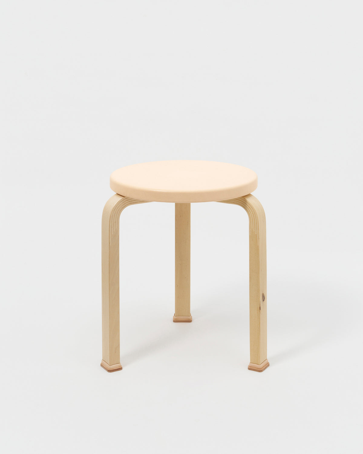 Stool with Shoes by Artek and Hender Scheme on gray background