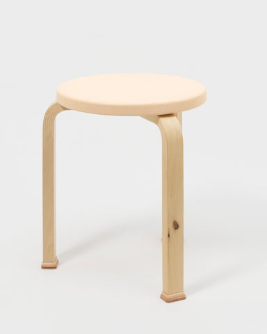 Stool with shoes by Artek and Hender Scheme on a gray background