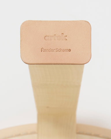 Up-close of shoe for table 90c by Hender Scheme and Artek on a gray background.