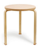 Leather table with shoes by Hender Scheme and Artek on a white background