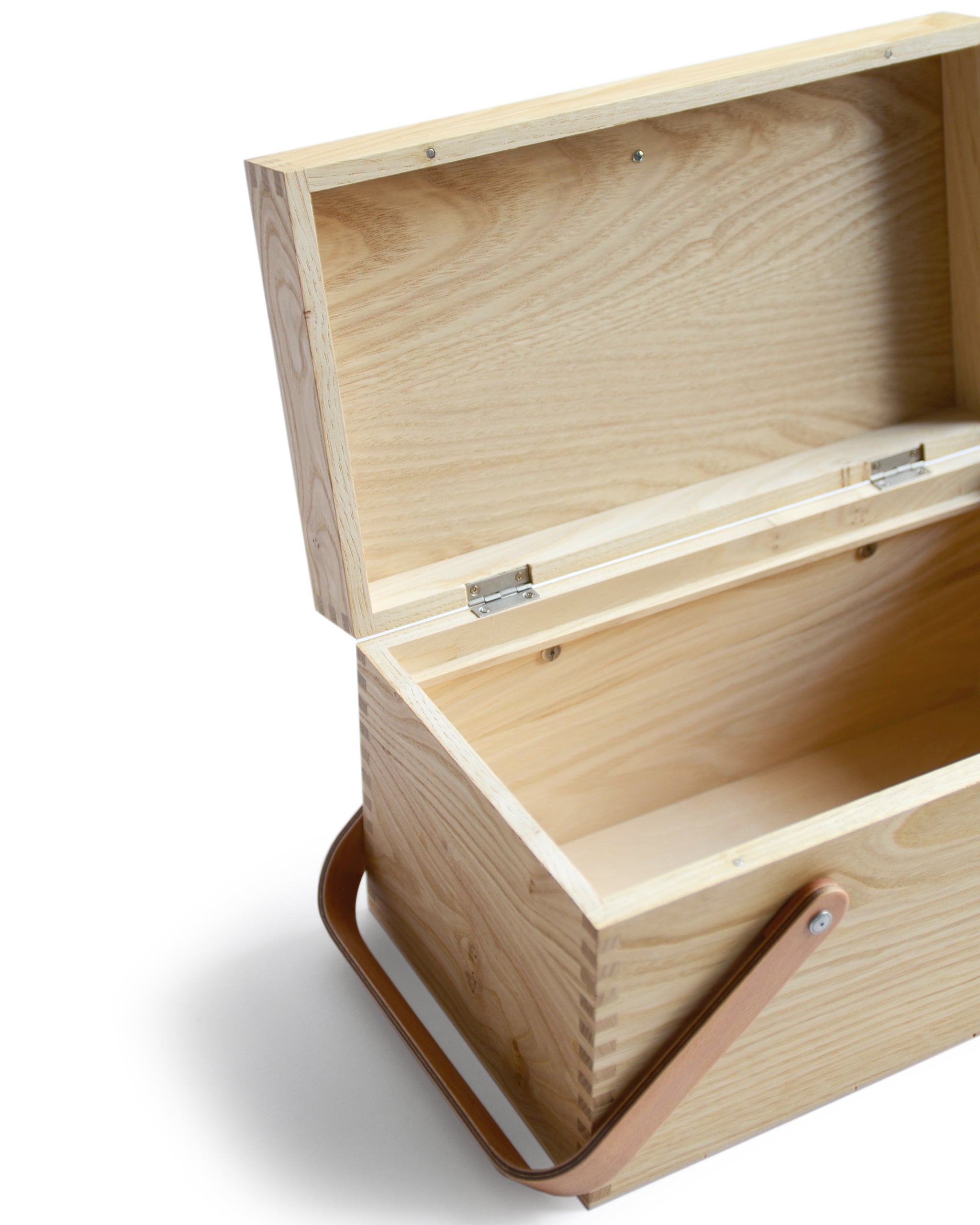 Cropped angled image of open chestnut wood picnic box featuring wood joinery on edges with inner compartments removed by Shinsuke Tanabe against white background.