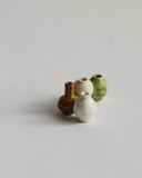 Image of  mini white, brown, green, and cream glazed mini vases clustered together from the Mini Vase Set - Quad by Dani Sujin x Nalata Nalata against white-gray background.
