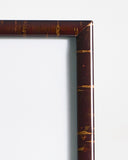 Up-close view of rectangular wooden frame by Denshiro on a gray background