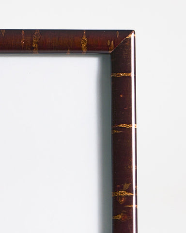 Up-close view of rectangular wooden frame by Denshiro on a gray background