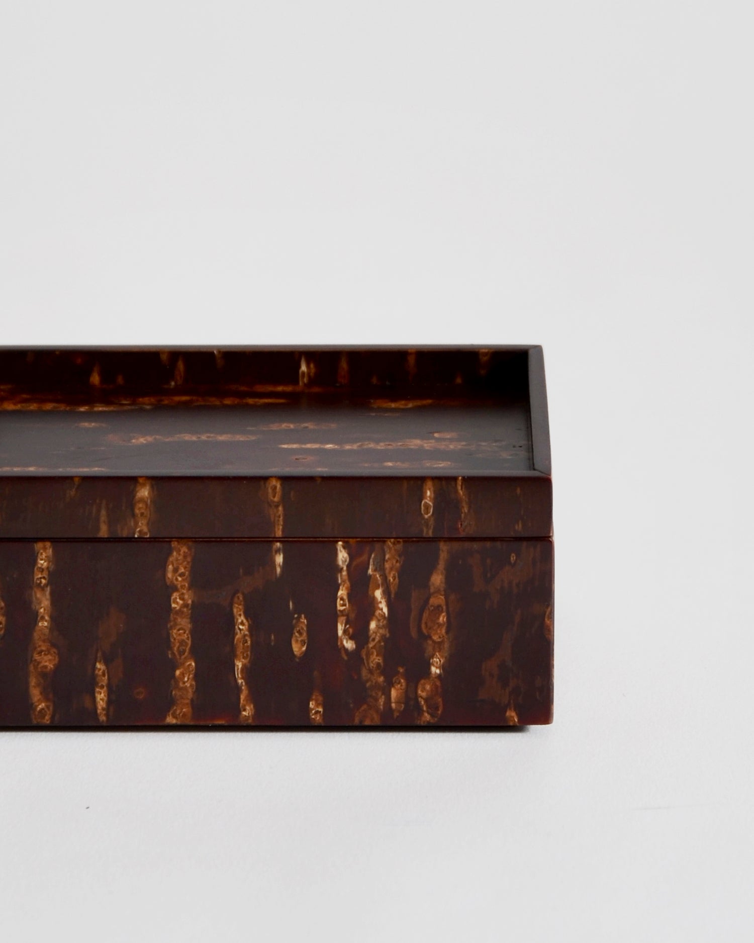 Up close view of wooden box by Denshiro on a light gray background