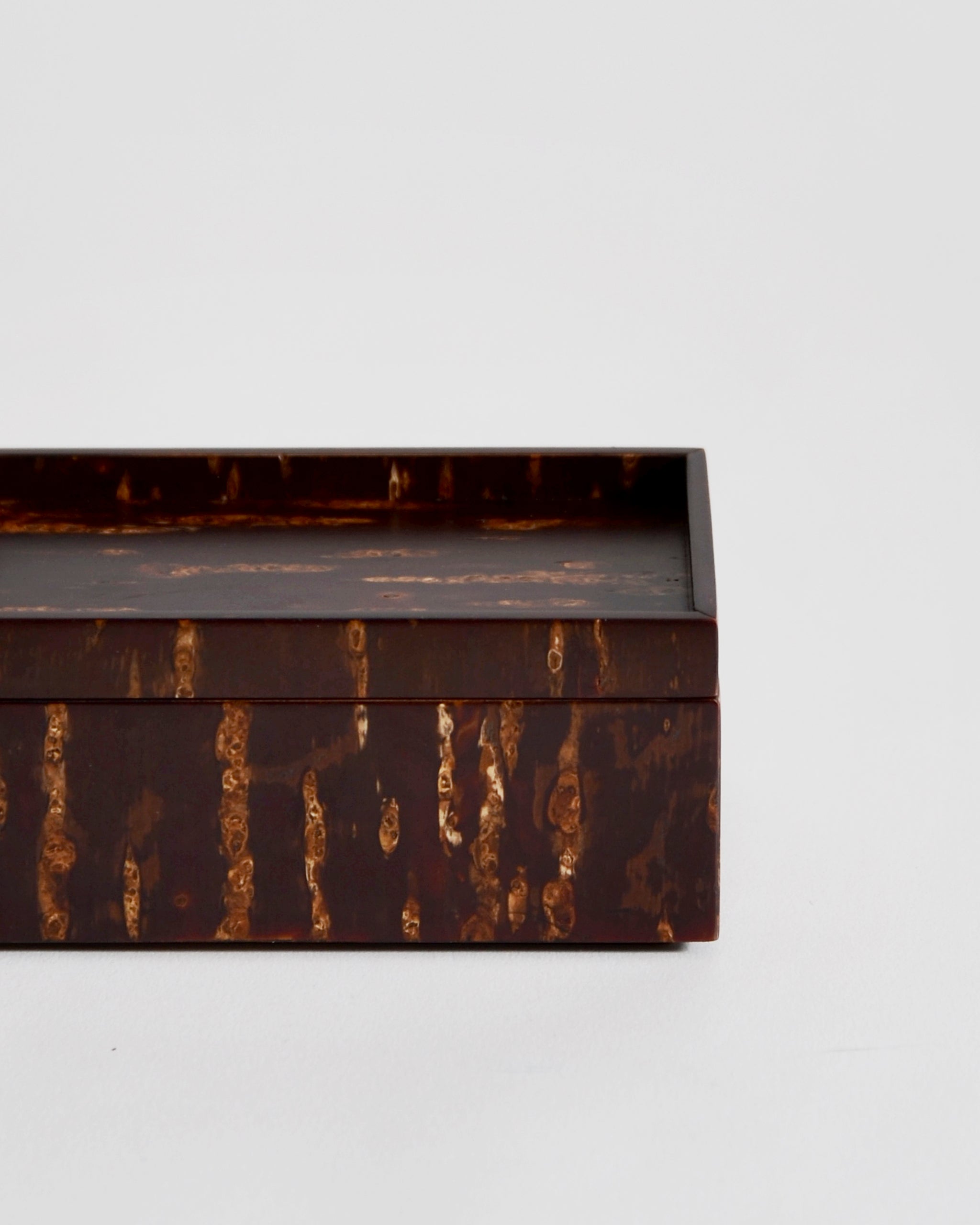 Up close view of wooden box by Denshiro on a light gray background