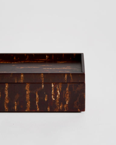 Up close view of wooden box by Denshiro on a light gray background