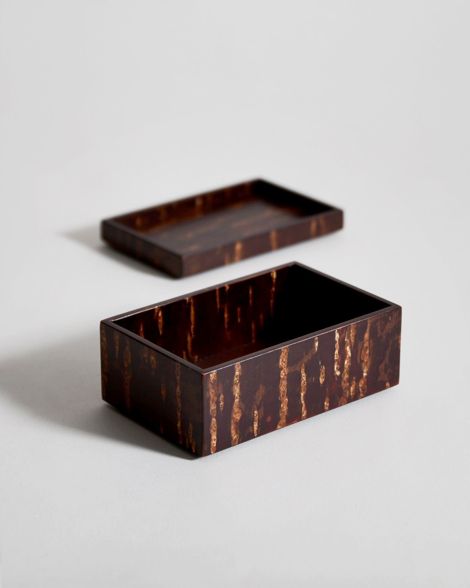 Open wooden rectangular box and tray lid by Denshiro laid separately on a light gray background