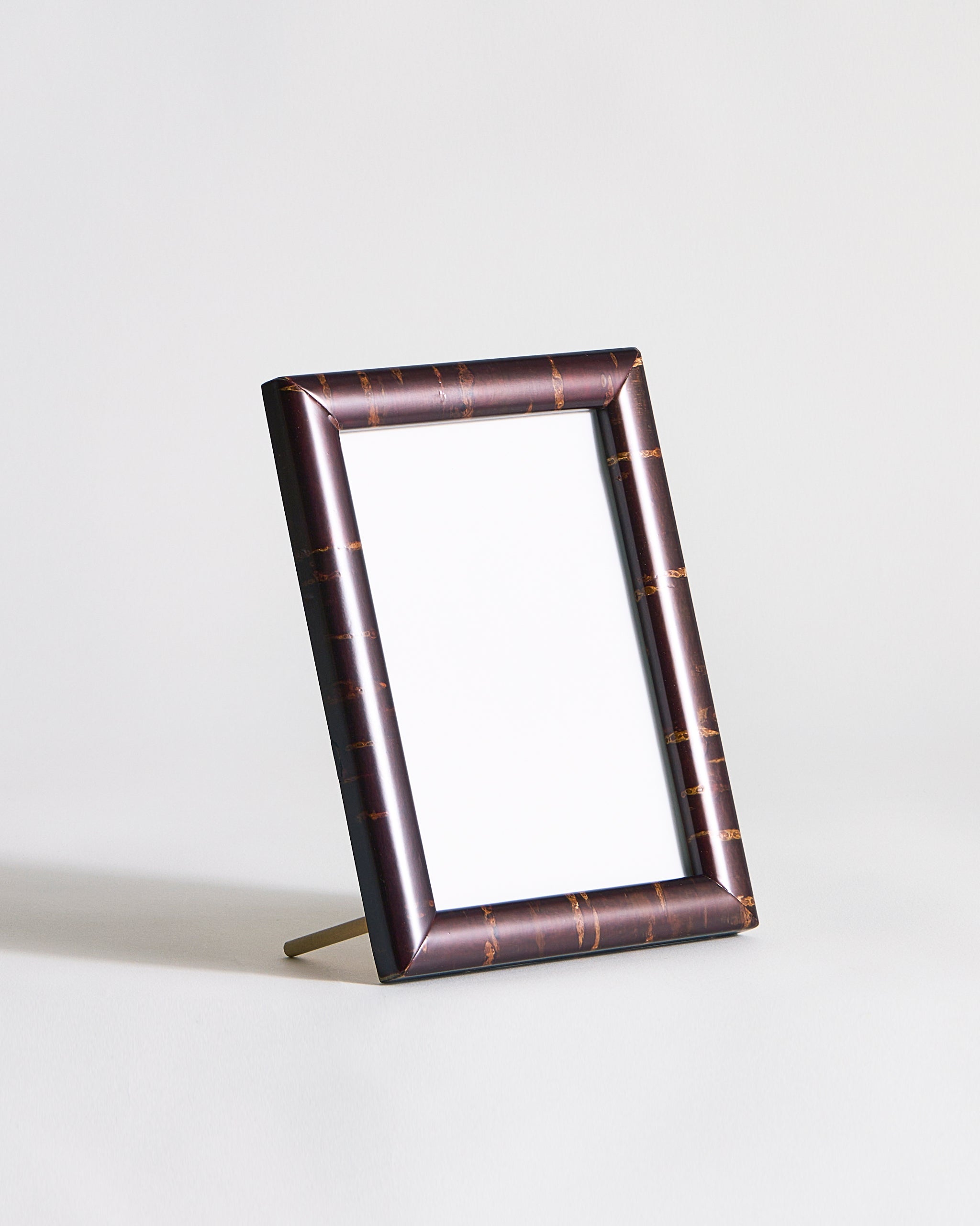Rectangular wooden frame with stand by Denshiro on a gray background 