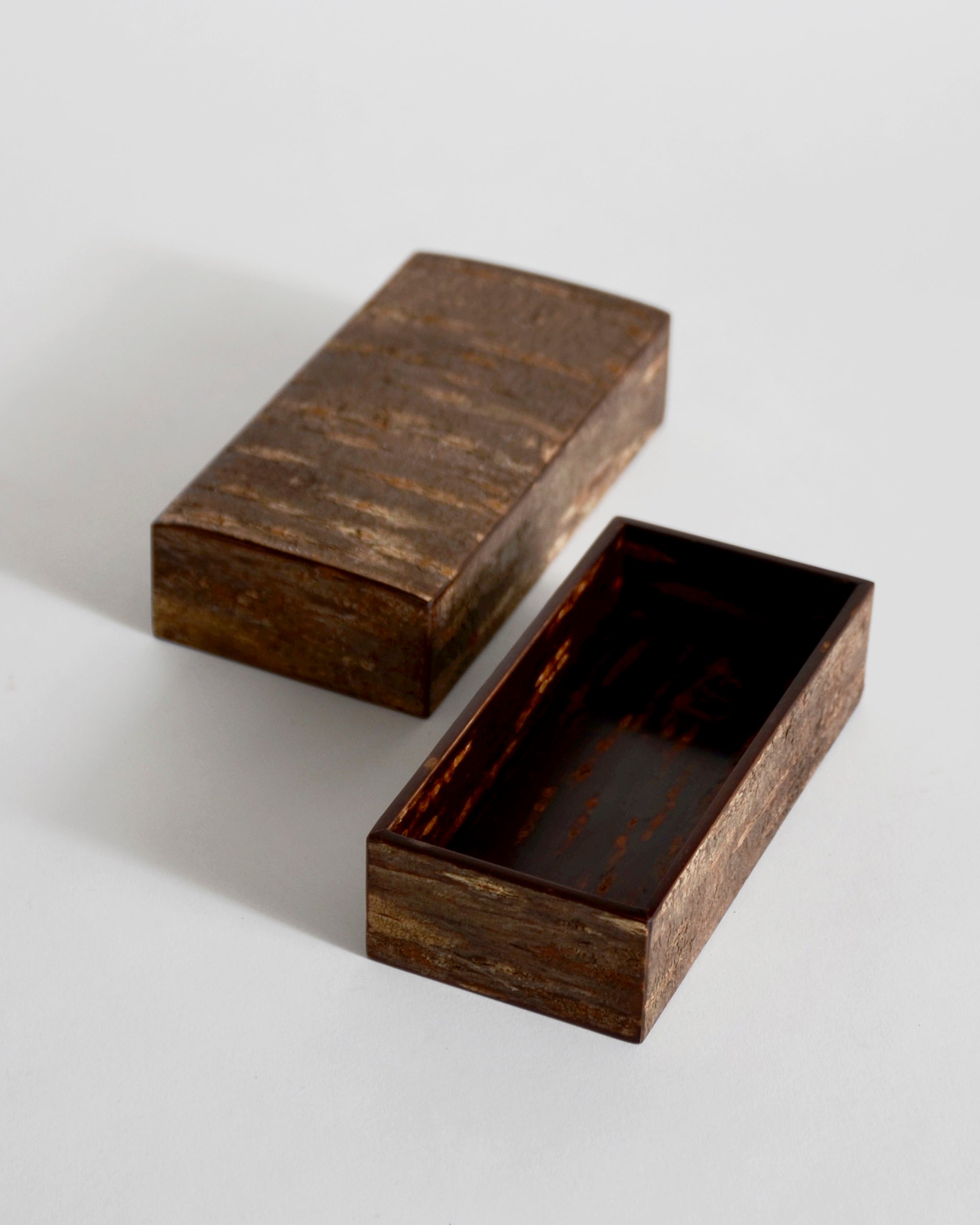 Open wooden small box with lid by Denshiro on a light gray background