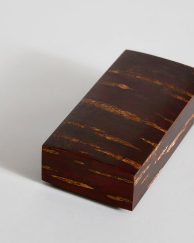 Small rectangular smooth wooden box on a gray background