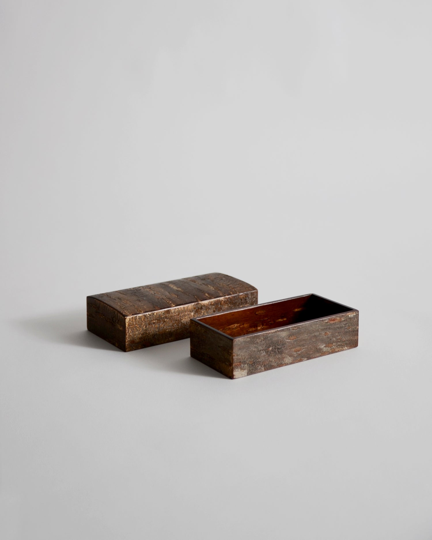 Open wooden small box with lid by Denshiro on a light gray background