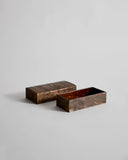Open wooden small box with lid by Denshiro on a light gray background