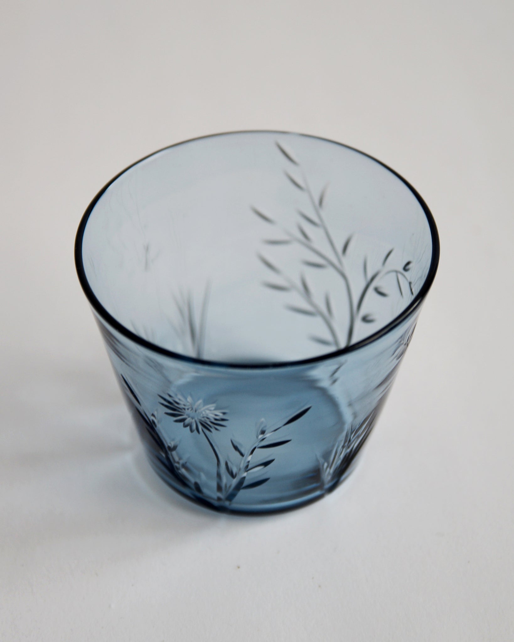 Detailed top view of the reclaimed blue ms.garden daily cup in light blue. Features a focus on carved flower and leaves pattern in front of the cup.