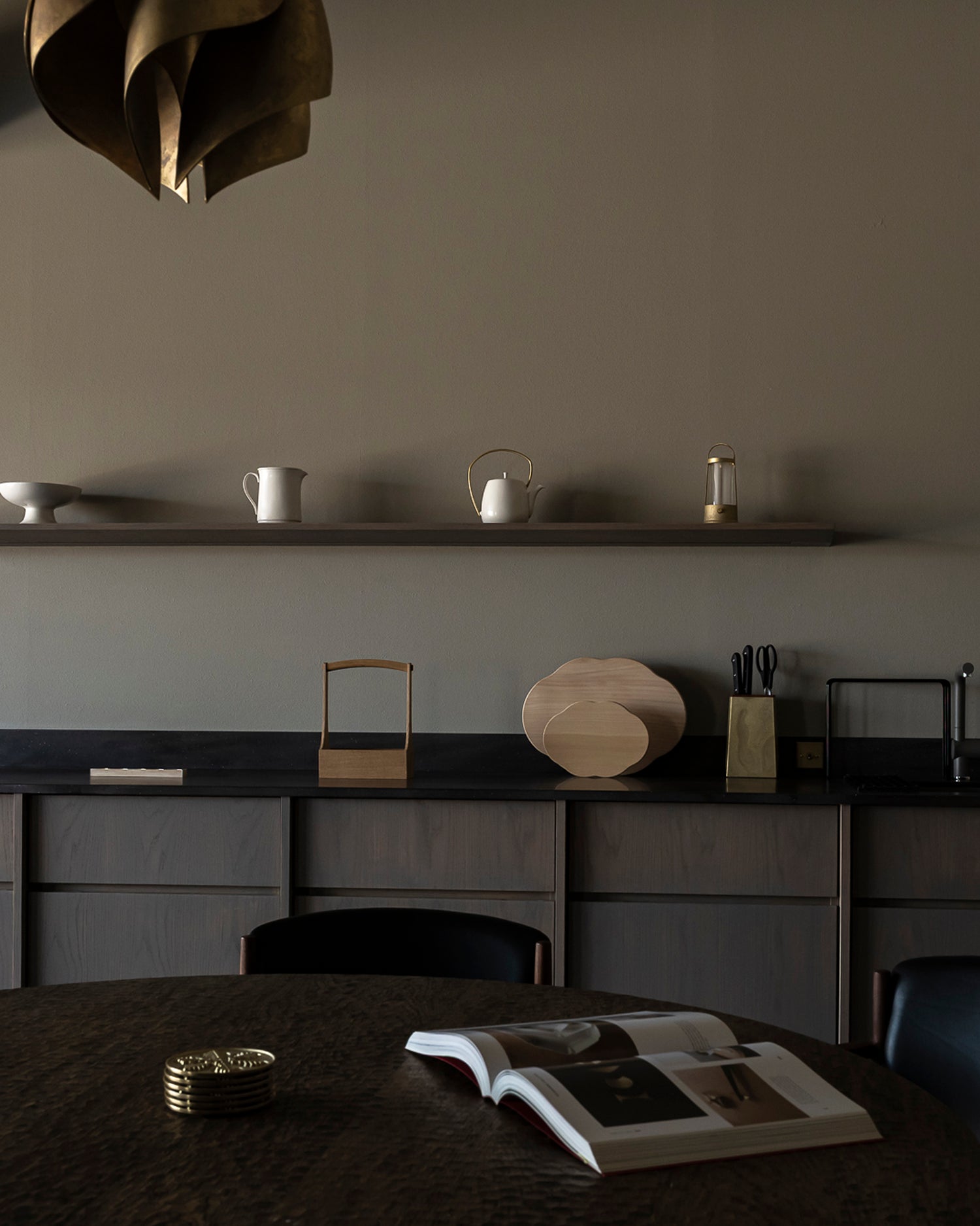Arc lantern by Futagami on a shelf in a kitchen surrounded by other items.