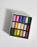 Box of colorful pastels by Ohkan Kagaku Kogyosyo on a gray background