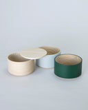 Unstacked Border Three Tiered Containers in Emerald, Blue Gray, Natural on a white background