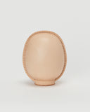 Back view of large leather Daruma doll by Hender Scheme in on  a gray background