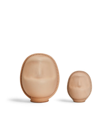 Two leather Daruma dolls by Hender Scheme in small and large on  a white background