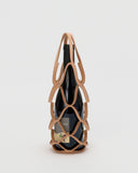 Wine bottle in wine holder by Hender Scheme with a gray background