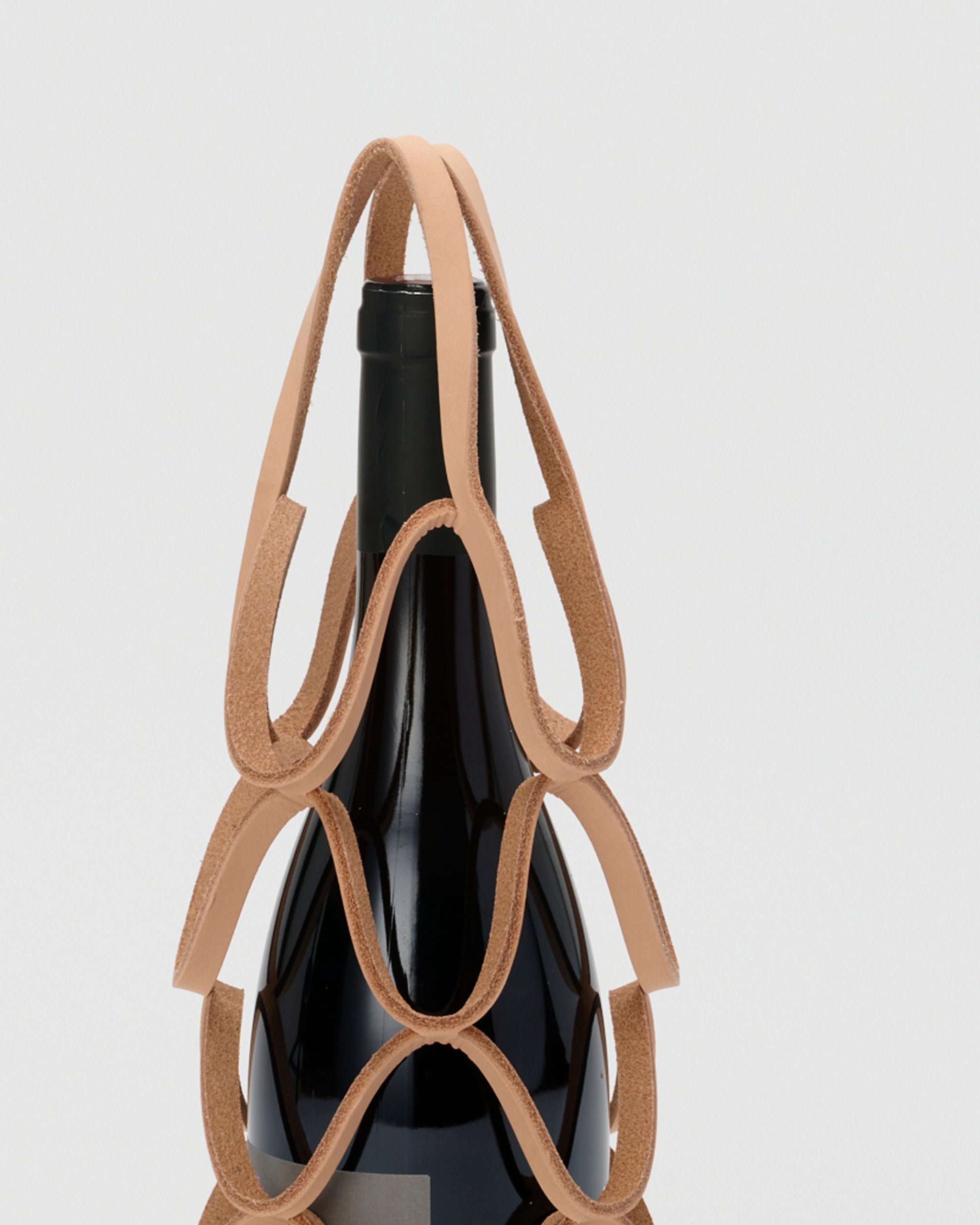 Close-up of handle for Wine bottle in wine holder by Hender Scheme with a gray background