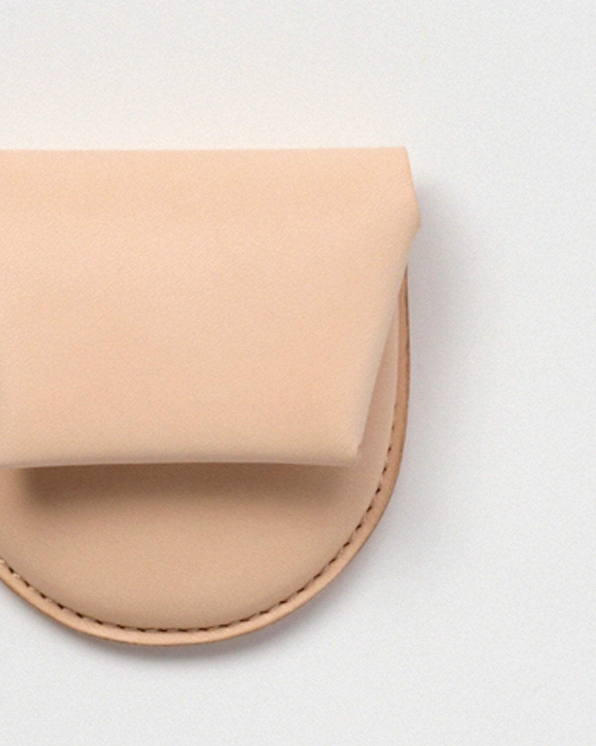 Up-close of Coin Case by Hender Scheme on a gray background