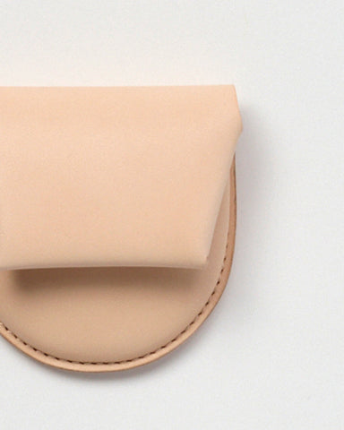 Up-close of Coin Case by Hender Scheme on a gray background