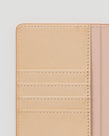 Close-up of open iPhone Case by Hender Scheme of card slots on a gray background.