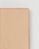Up-close of Leather Passport Case by Hender Scheme on a gray background