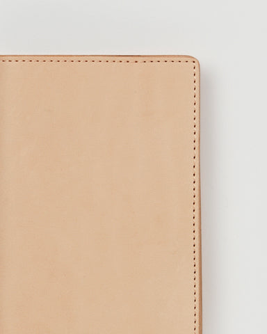 Up-close of Leather Passport Case by Hender Scheme on a gray background