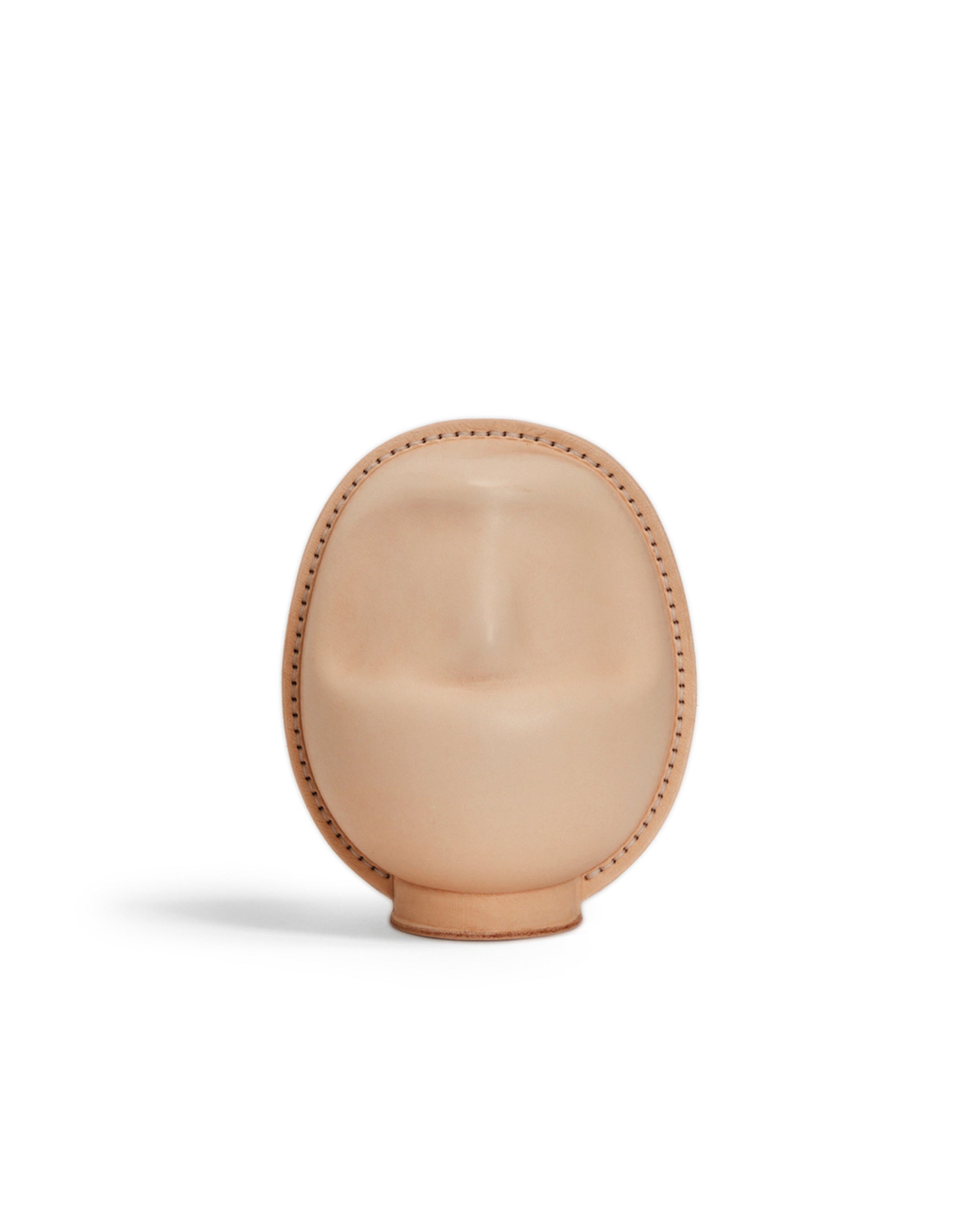 Large leather Daruma doll by Hender Scheme on  a white background