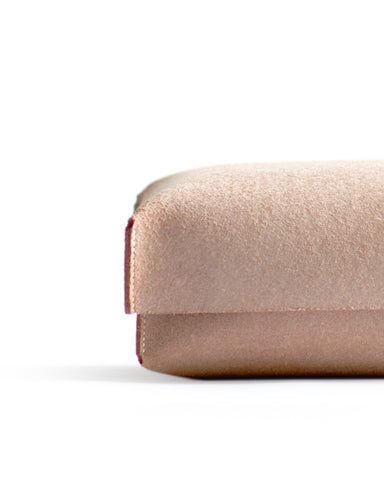 Cropped detail of the hender scheme two piece box featuring its rough natural leather texture.