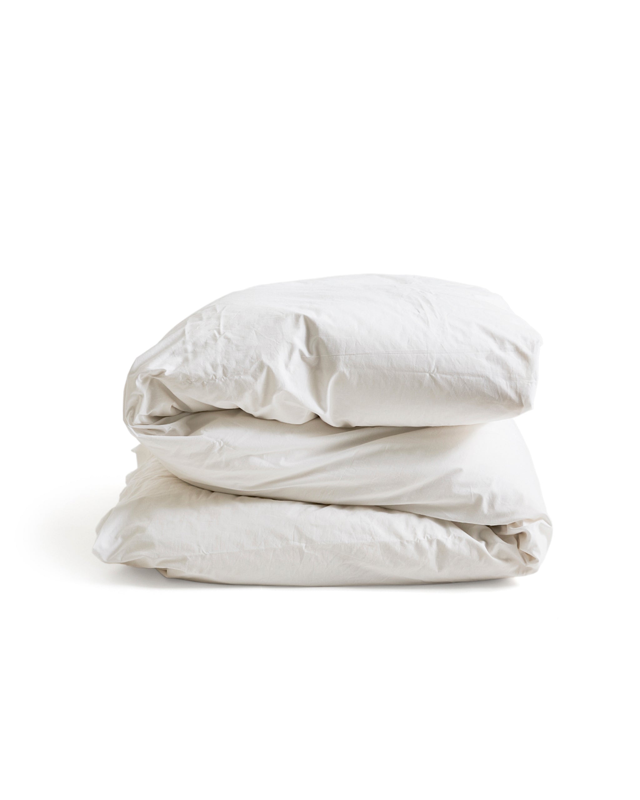 Folded white duvet cover on a duvet by Iwata on a white background