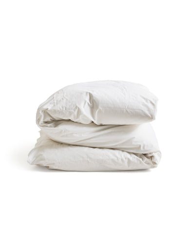 Folded white duvet cover on a duvet by Iwata on a white background