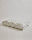 Storage bag for Camel Heavy Mattress Pad by Iwata on a gray background
