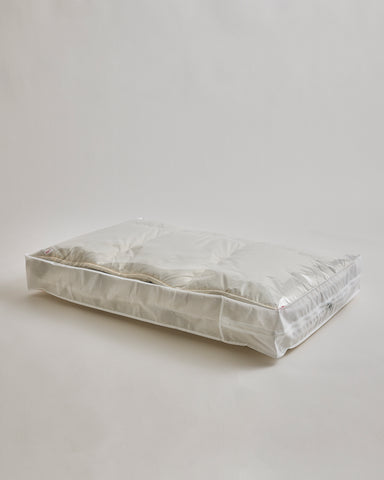Storage bag for Camel Heavy Mattress Pad by Iwata on a gray background