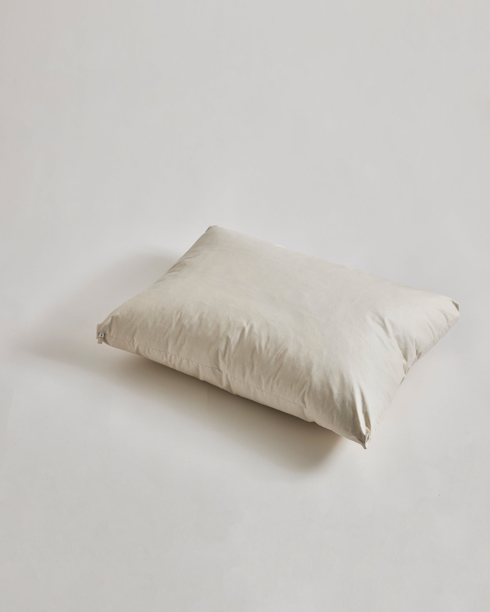 Down and Feather Pillow by Iwata on gray background