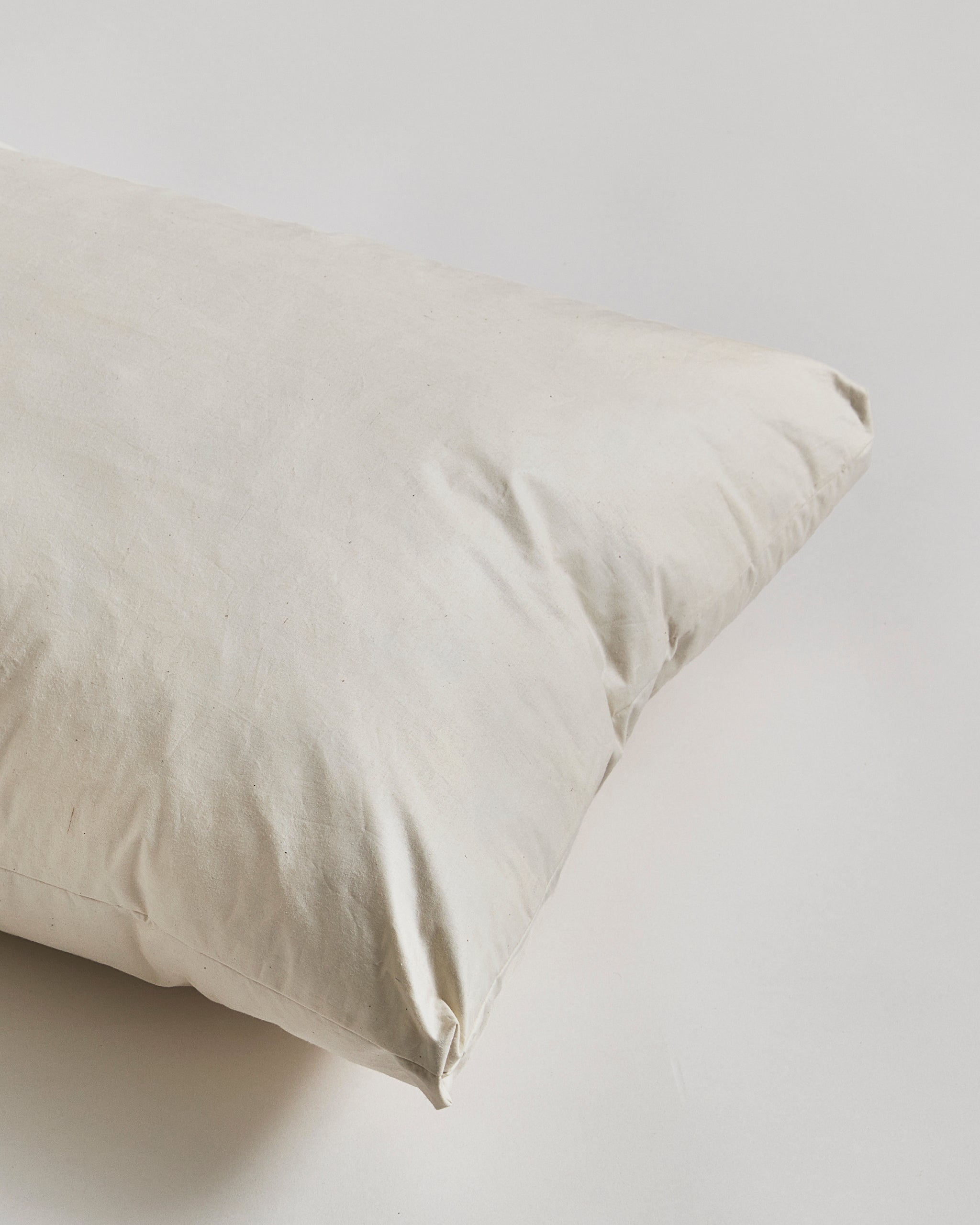 Close-up of Down and Feather Pillow by Iwata on gray background