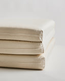Up-close of tri-fold futon floor pad by Iwata on a light gray background