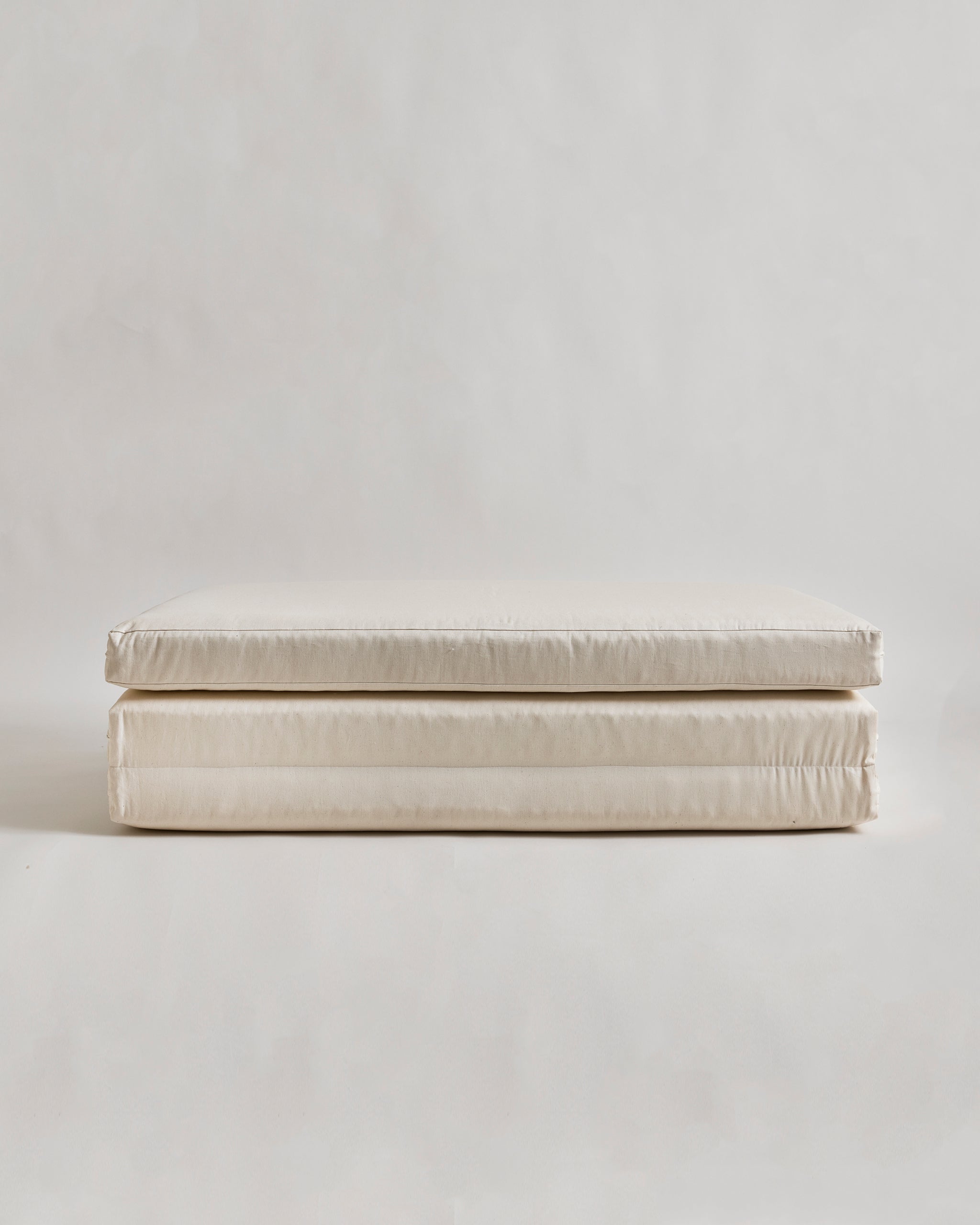 tri-fold futon floor pad by Iwata on a light gray background