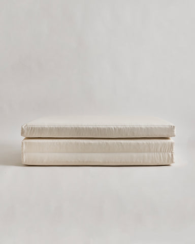 tri-fold futon floor pad by Iwata on a light gray background