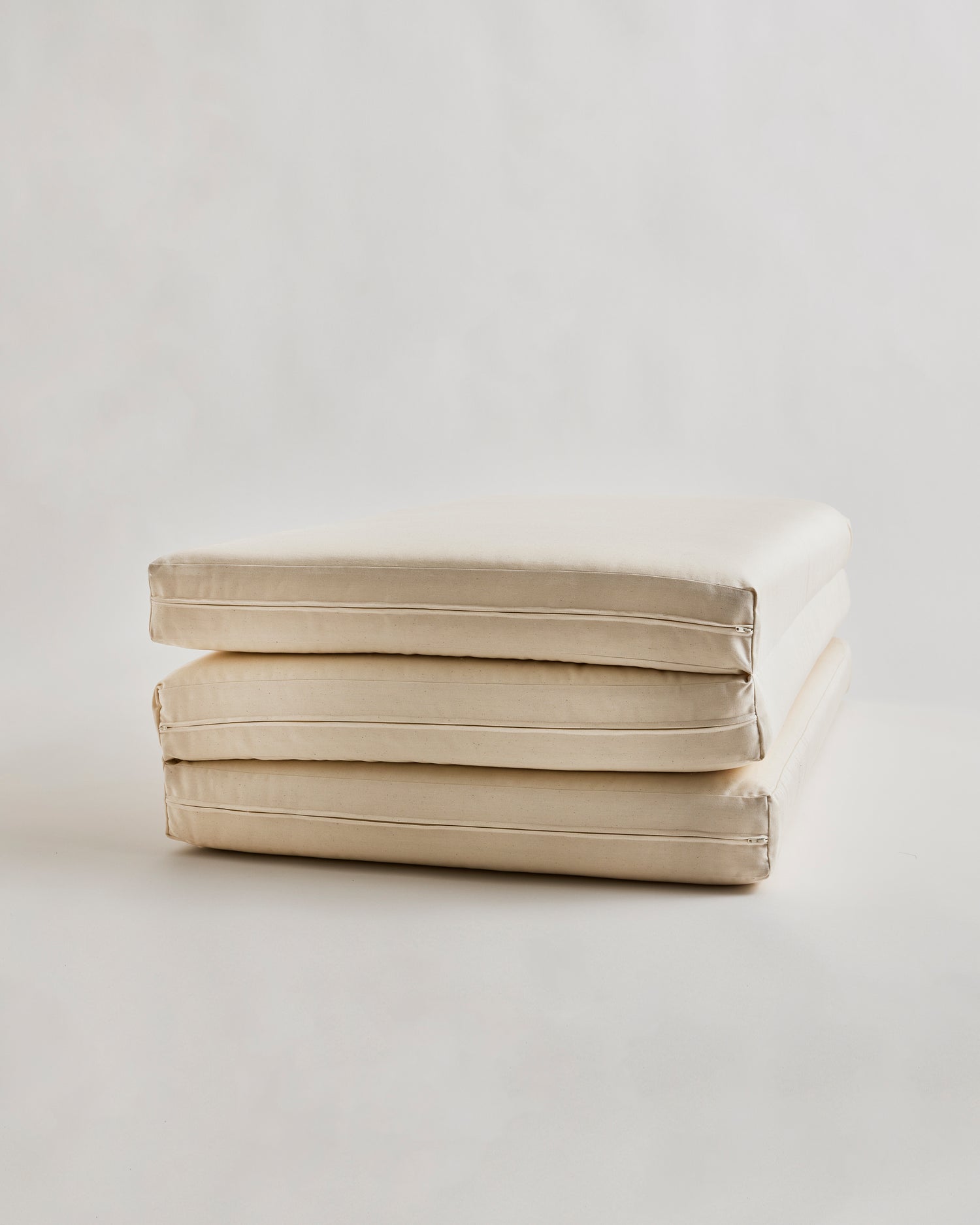 tri-fold futon floor pad by Iwata on a light gray background